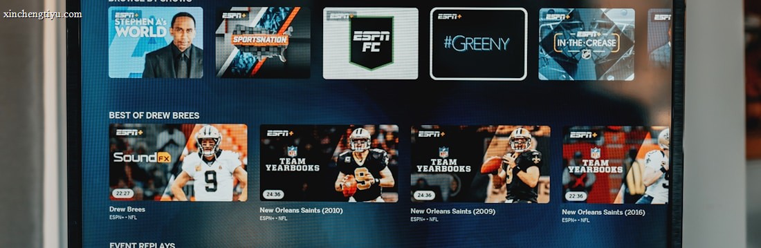 A television screen displaying the ESPN+ streaming interface with various sports-related shows and categories. The screen includes sections such as 'Browse by Shows' and 'Best of Drew Brees' with thumbnails of sports programs featuring athletes in action and analysts.